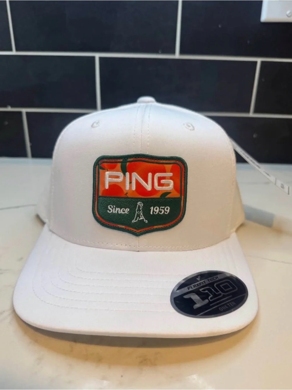 Ping White Hat with Orange and Green Patch
